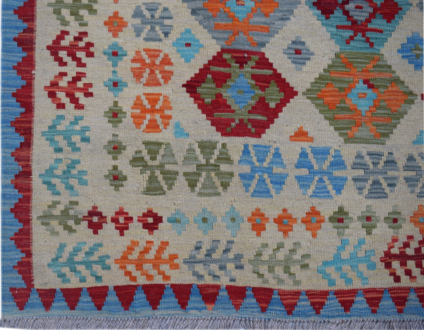 Handwoven Afghan Maimana kilim featuring a geometric pattern in vibrant multicolored wool.