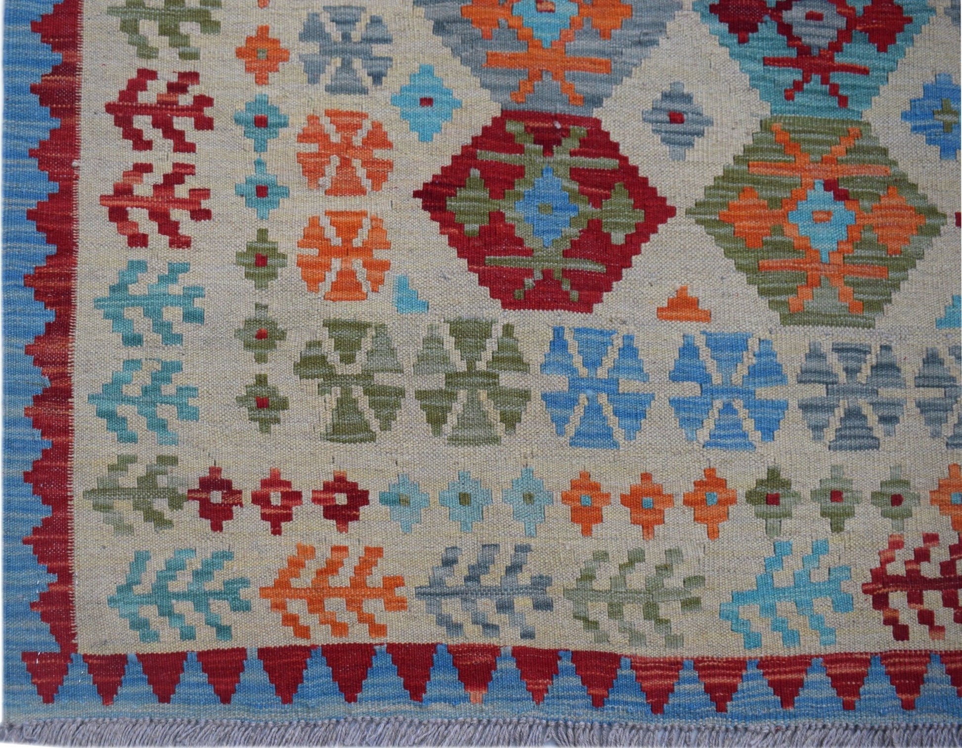 Handwoven Afghan Maimana kilim featuring a geometric pattern in vibrant multicolored wool.