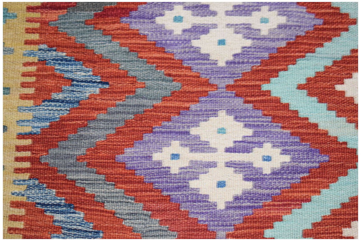 Afghan Maimana Kilim with geometric diamond patterns in red, blue, purple, and light blue.