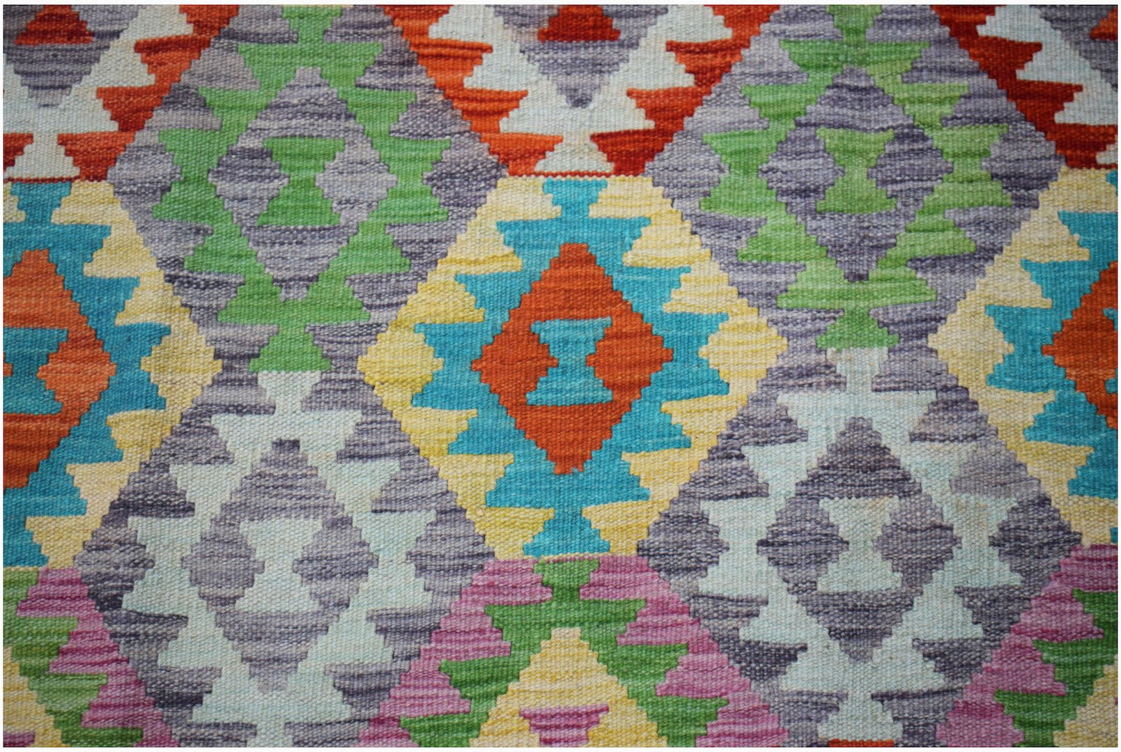 Afghan Maimana Kilim with geometric diamond patterns in multiple colors.