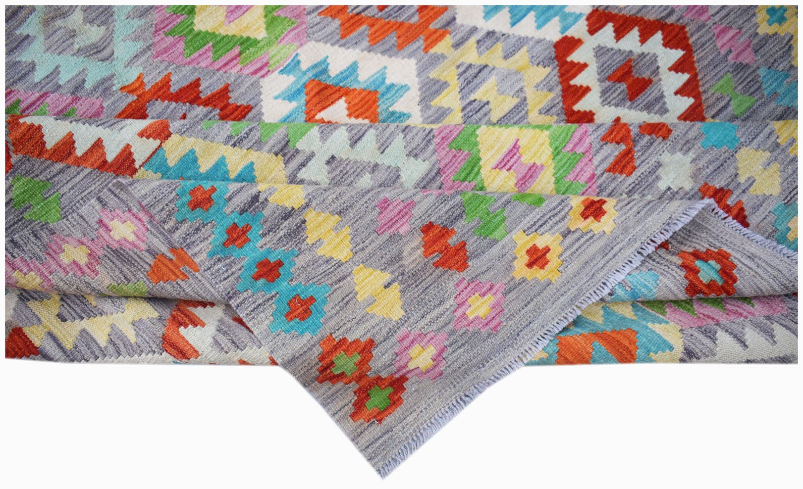Handwoven Afghan Maimana kilim rug featuring a colorful geometric pattern on a grey background.