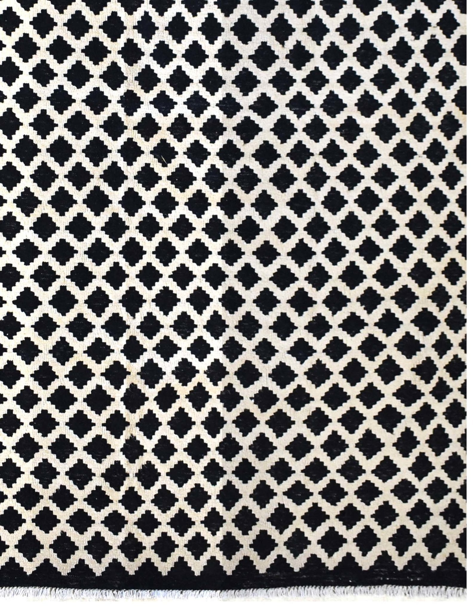 Handmade Afghan Maimana kilim rug featuring a repeating black and white geometric pattern.