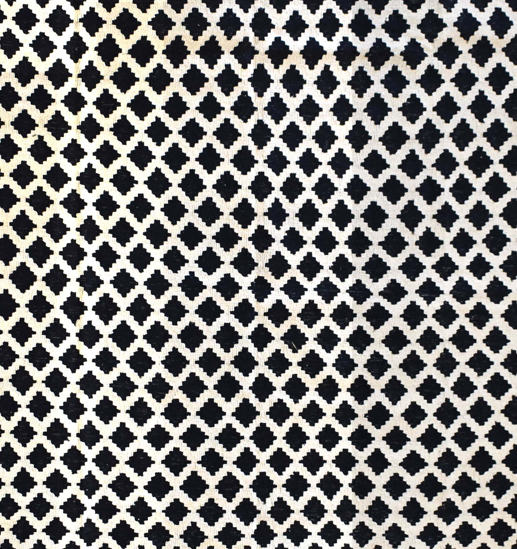 Handmade Afghan Maimana kilim rug featuring a repeating black and white geometric lattice pattern.