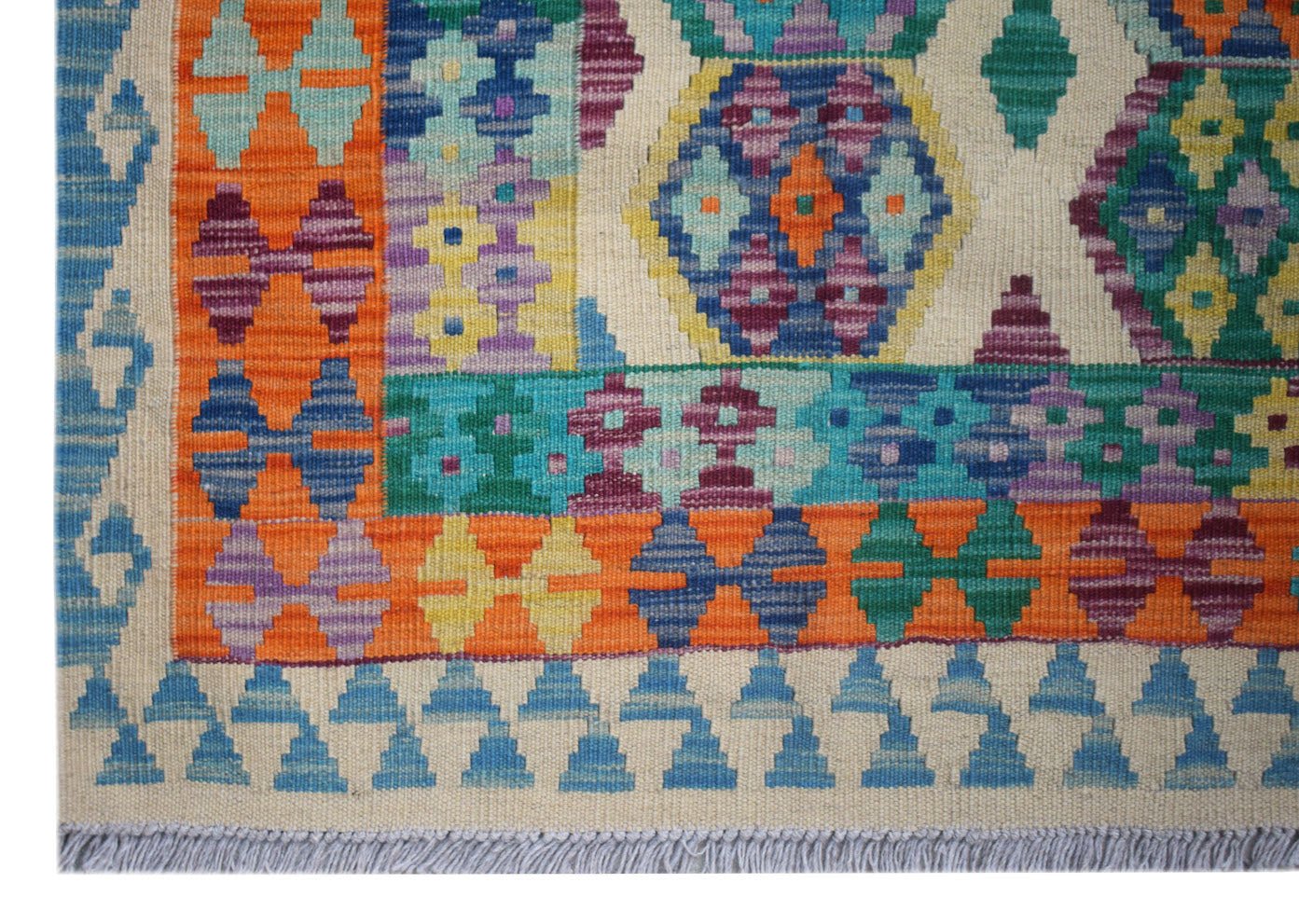 Handwoven Afghan Maimana kilim featuring a vibrant geometric pattern in wool.