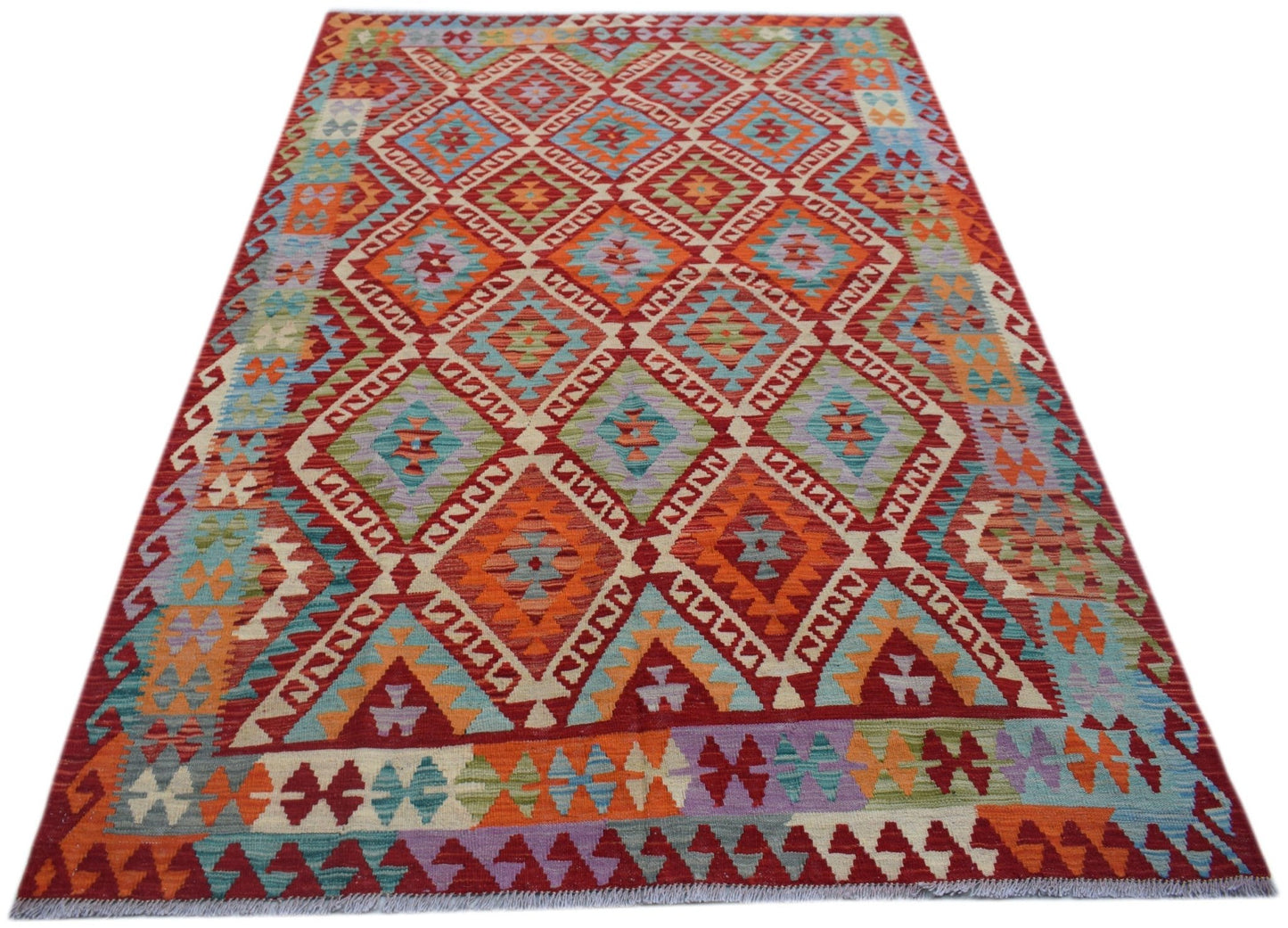 Handwoven Afghan Maimana kilim rug featuring a vibrant geometric diamond pattern in wool.