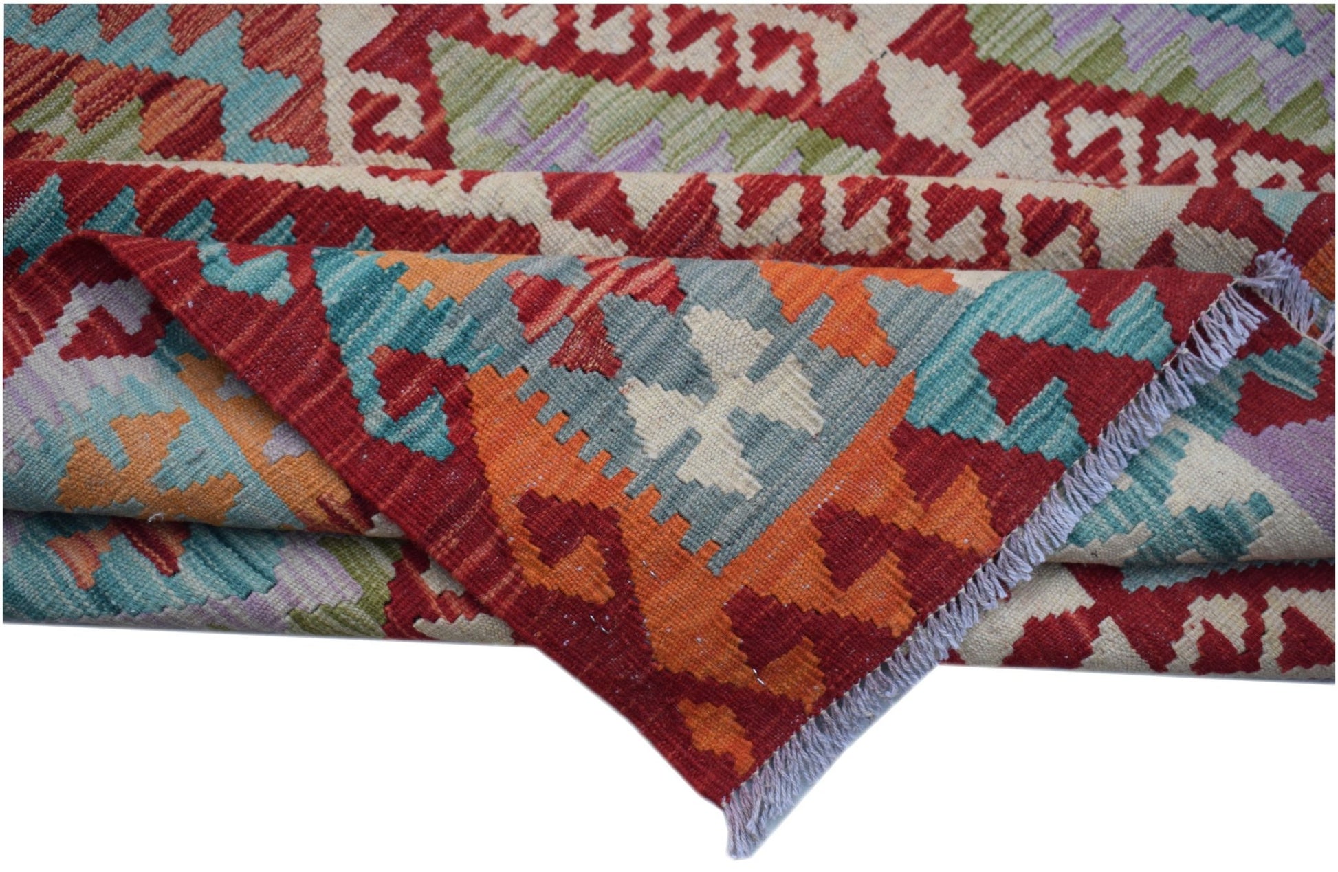 A handwoven Afghan Maimana kilim featuring geometric patterns in red, orange, blue, and green.