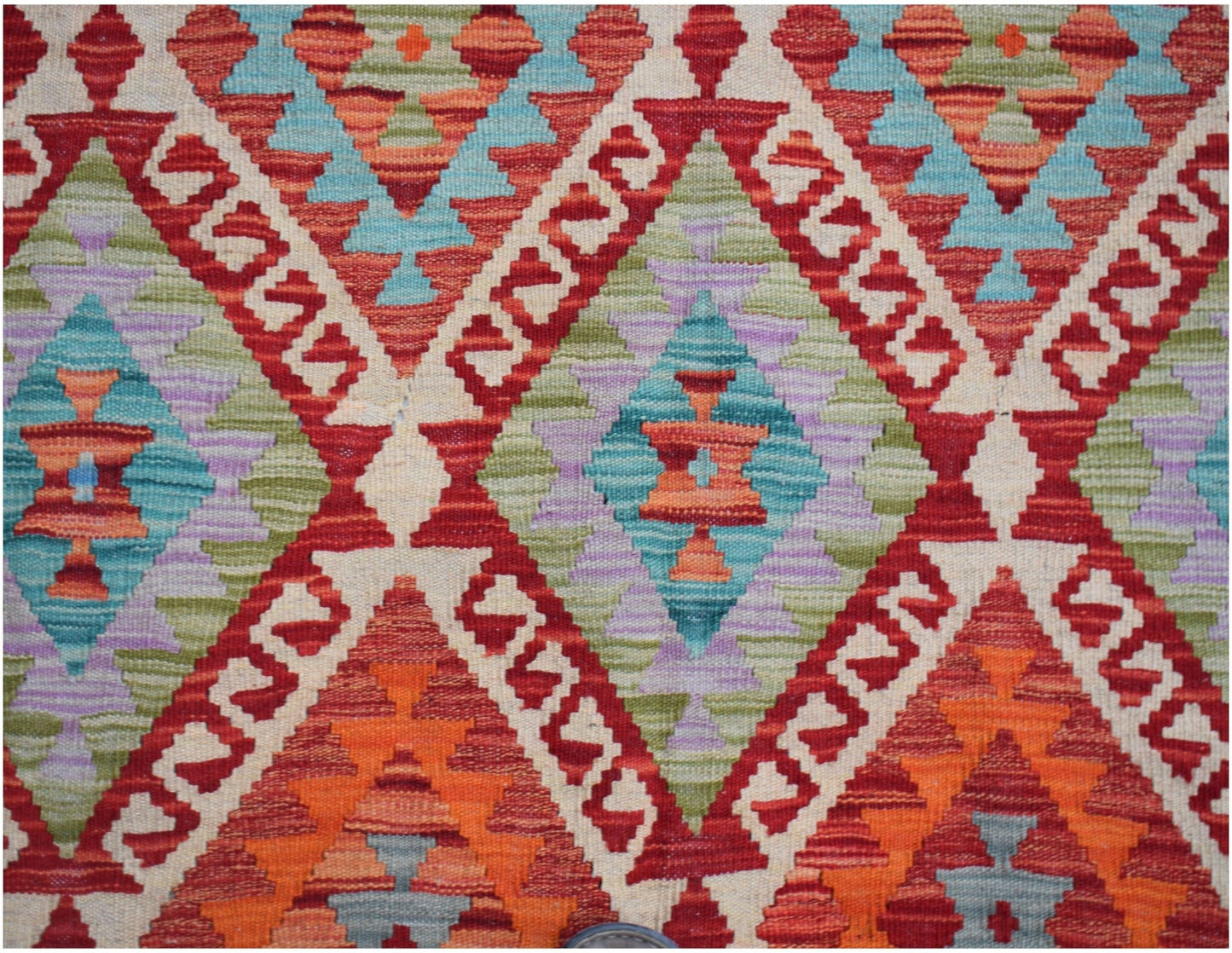 Handwoven Afghan Maimana kilim featuring a geometric diamond pattern in vibrant wool colors.