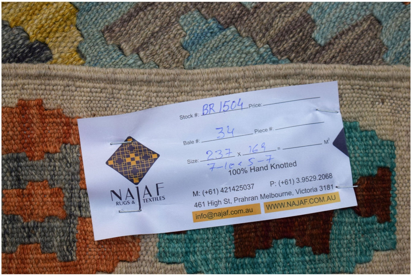 A handwoven Afghan Maimana kilim featuring a geometric pattern in blue, orange, and yellow tones.