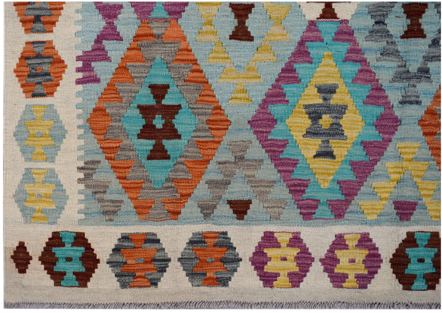 Handwoven Afghan Maimana kilim featuring a geometric pattern in vibrant multicolored diamonds.