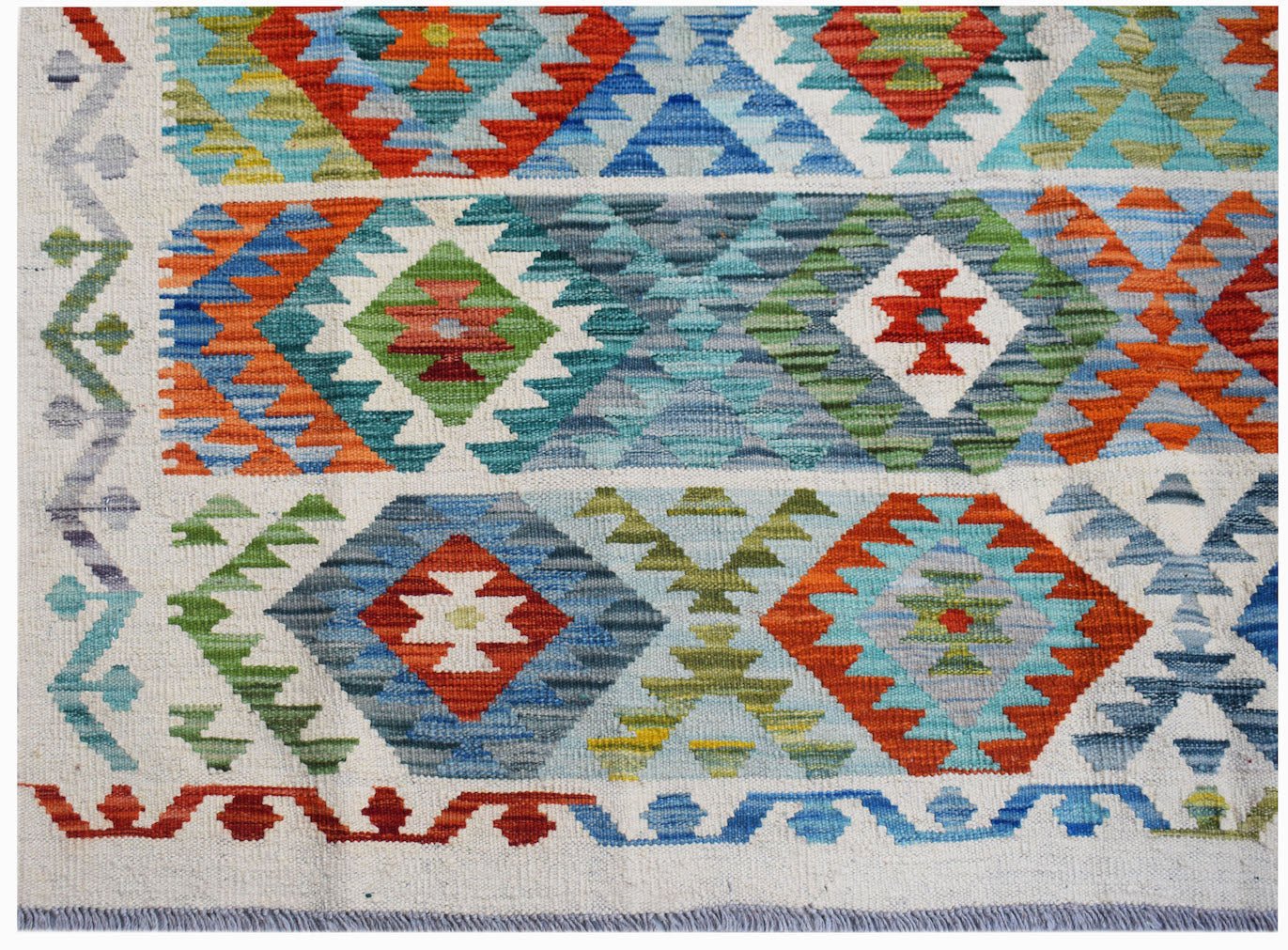Handwoven Afghan Maimana kilim rug featuring a colorful geometric pattern on a cream background.