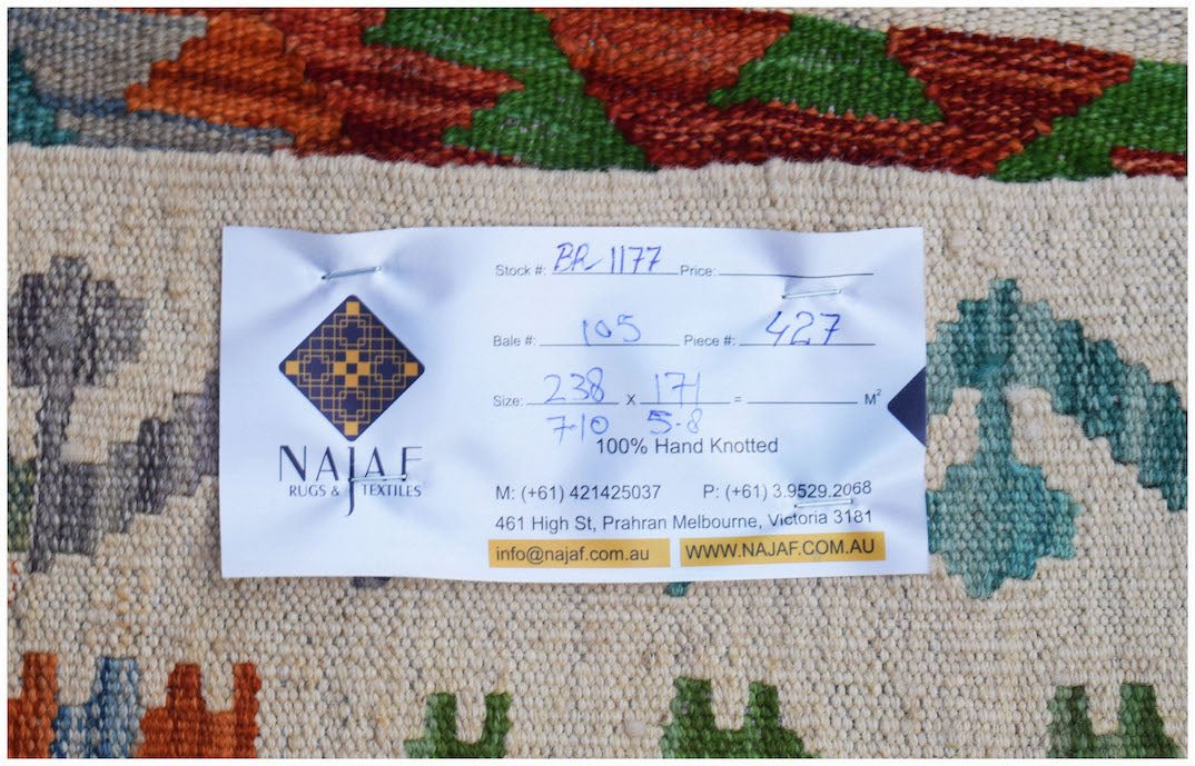 A handmade Afghan Maimana kilim featuring a flatweave texture and colorful geometric patterns.