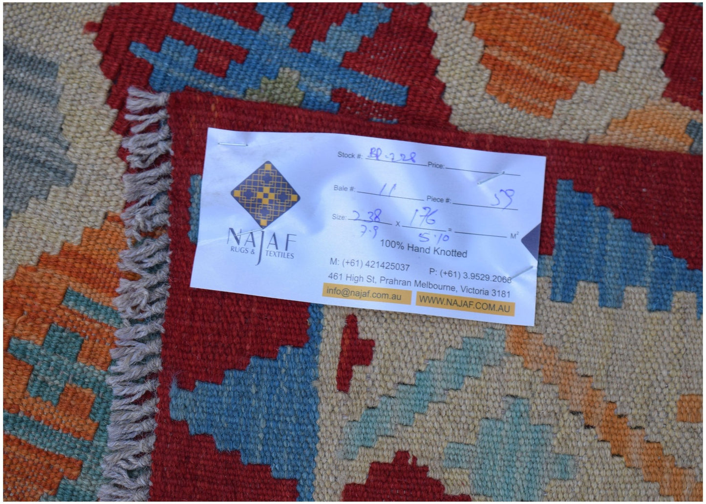A handwoven Afghan Maimana kilim featuring a geometric pattern in red, blue, and orange tones.