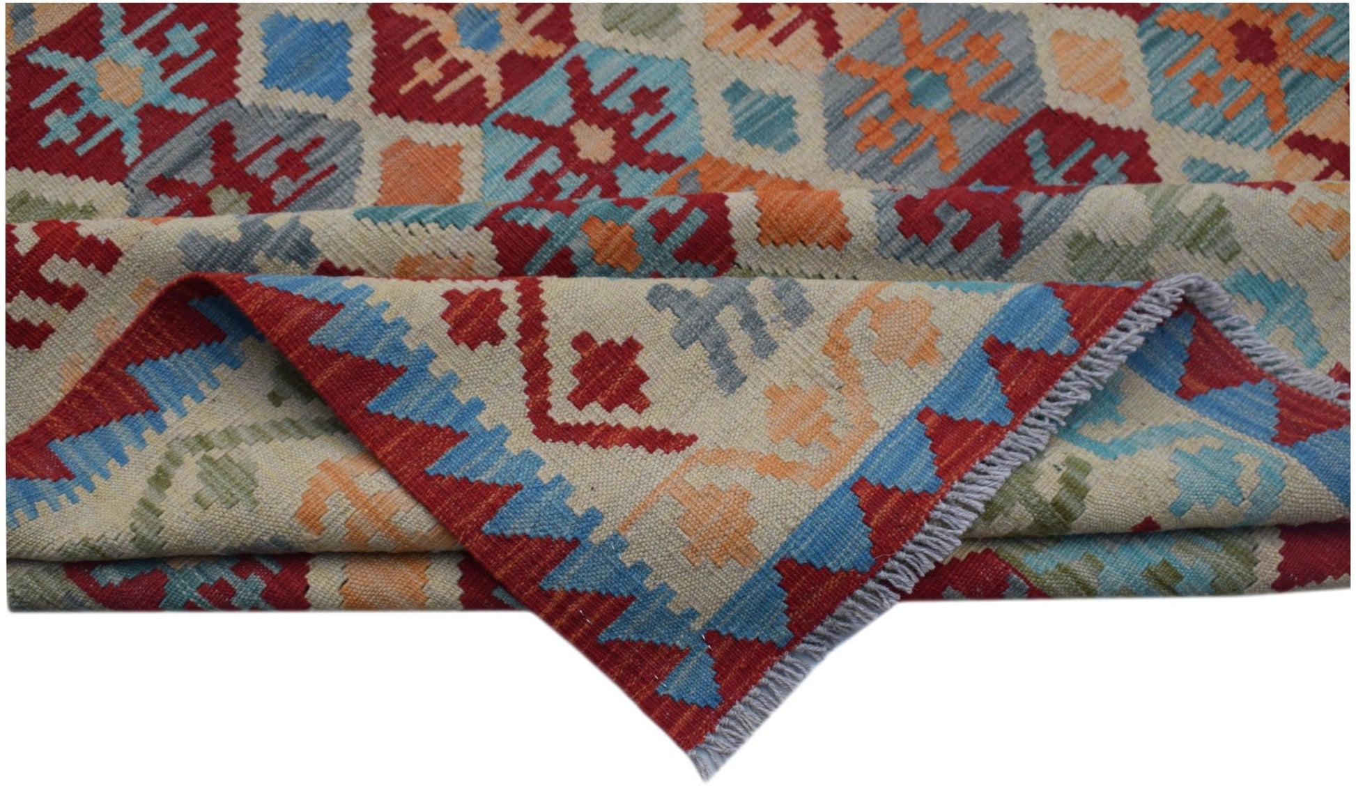 A handmade Afghan Maimana kilim rug featuring a colorful geometric pattern on a cream background.