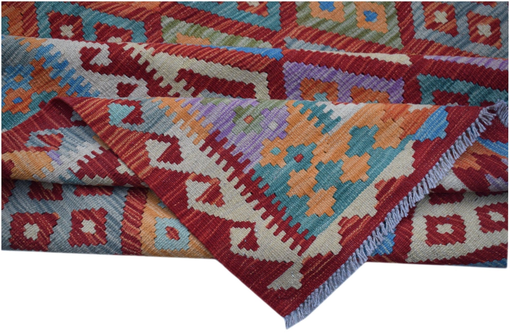 A handwoven Afghan Maimana kilim rug featuring a vibrant geometric pattern in wool.