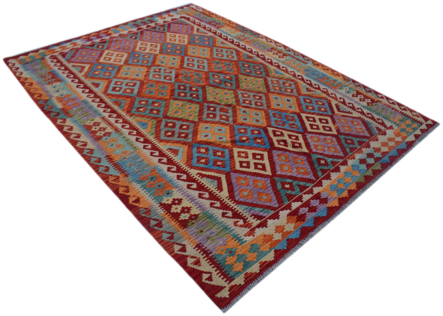 A rectangular Afghan Maimana kilim rug featuring a colorful geometric diamond pattern.
