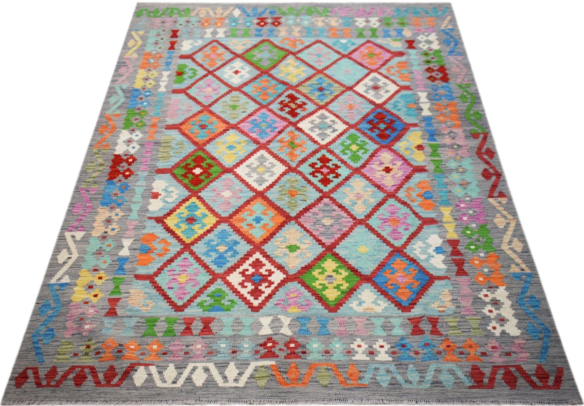 Handwoven Afghan Maimana kilim rug featuring a colorful geometric diamond pattern on a grey field.
