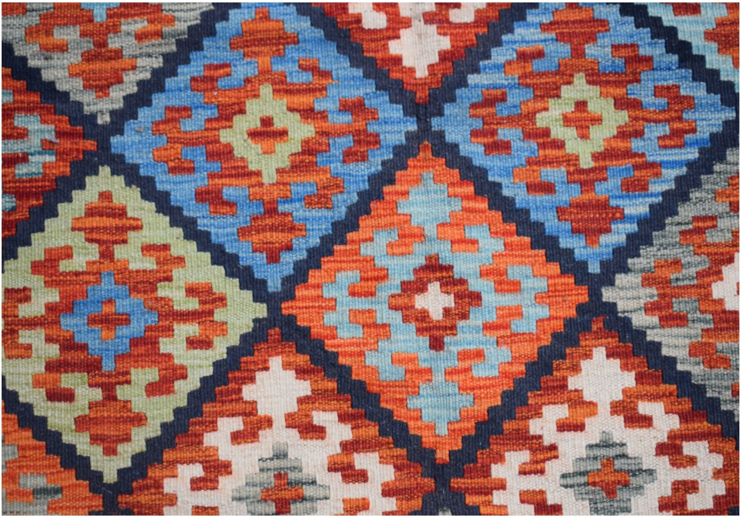 Handwoven Afghan Maimana kilim featuring a vibrant geometric diamond pattern in wool.
