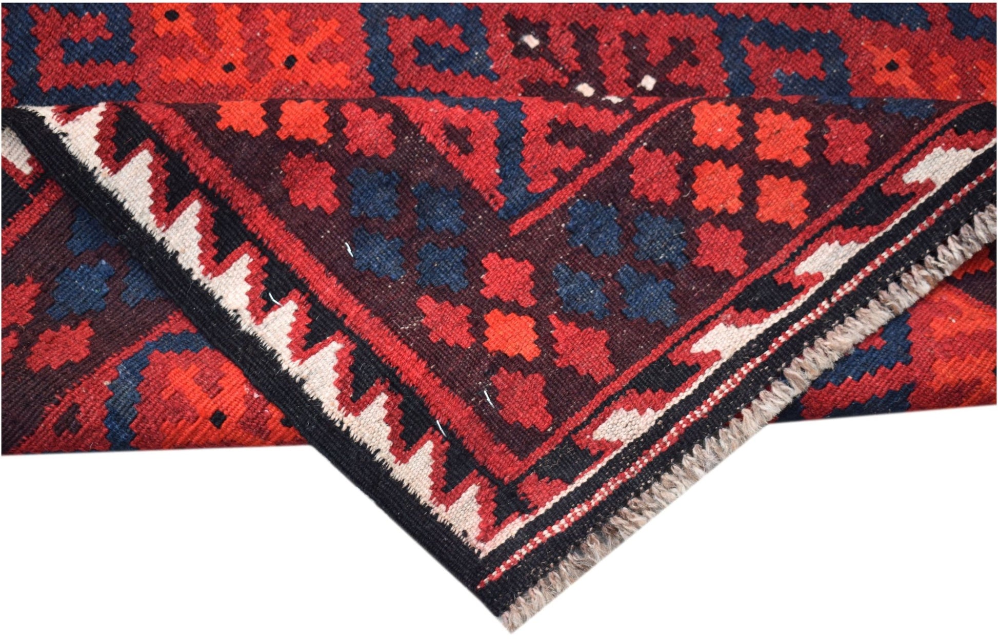 A handmade Afghan Maimana kilim featuring a geometric pattern in red, blue, and cream wool.
