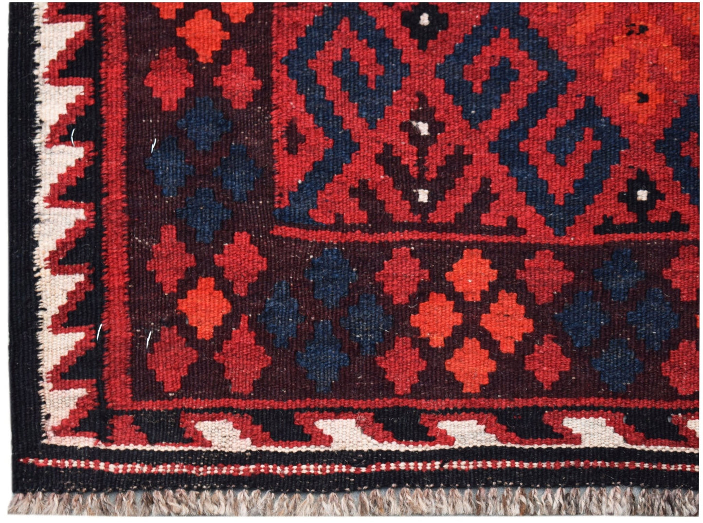 Handwoven Afghan Maimana kilim featuring geometric patterns in red, blue, and cream wool.