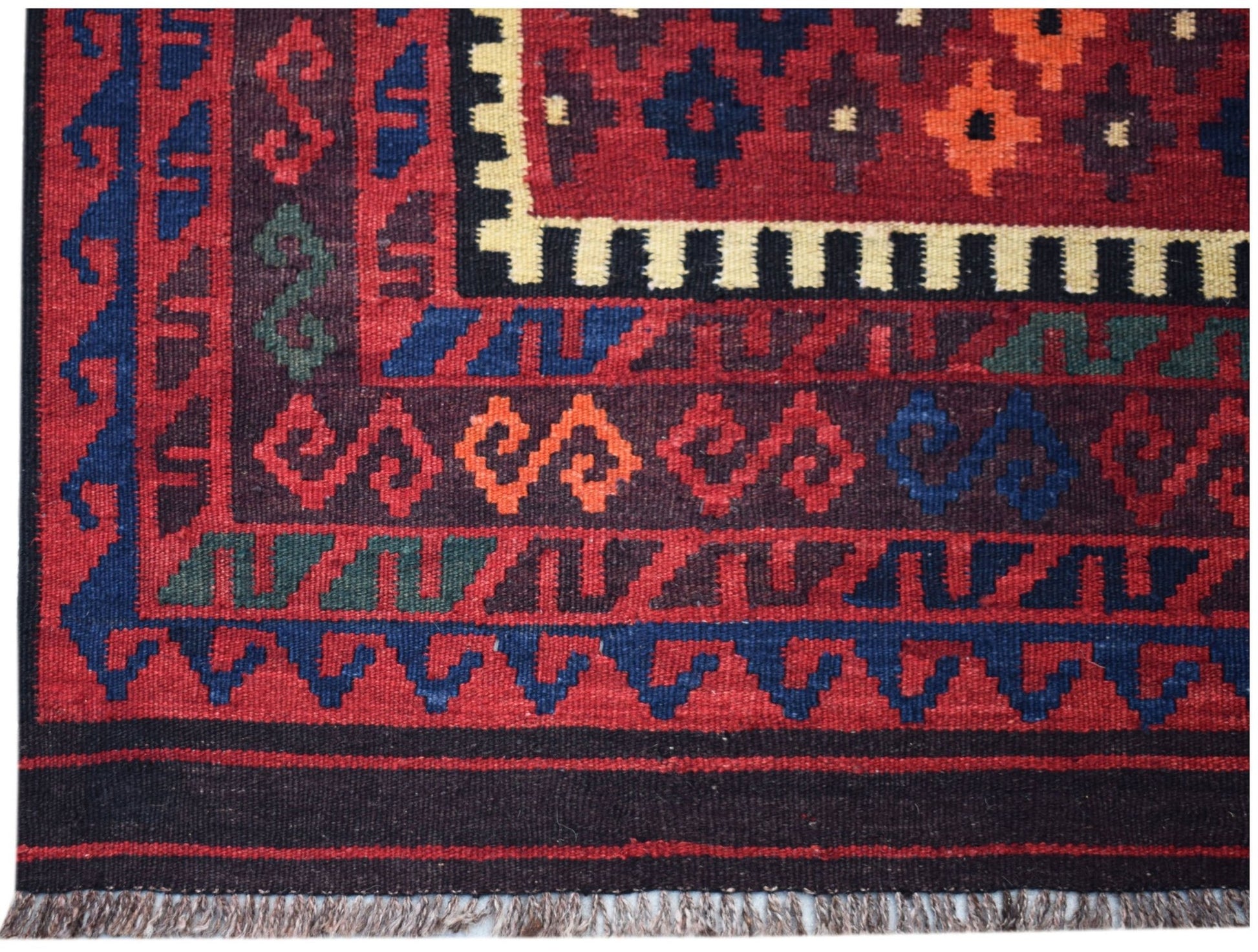 Handwoven Afghan Maimana kilim featuring geometric patterns in red, blue, and orange wool.