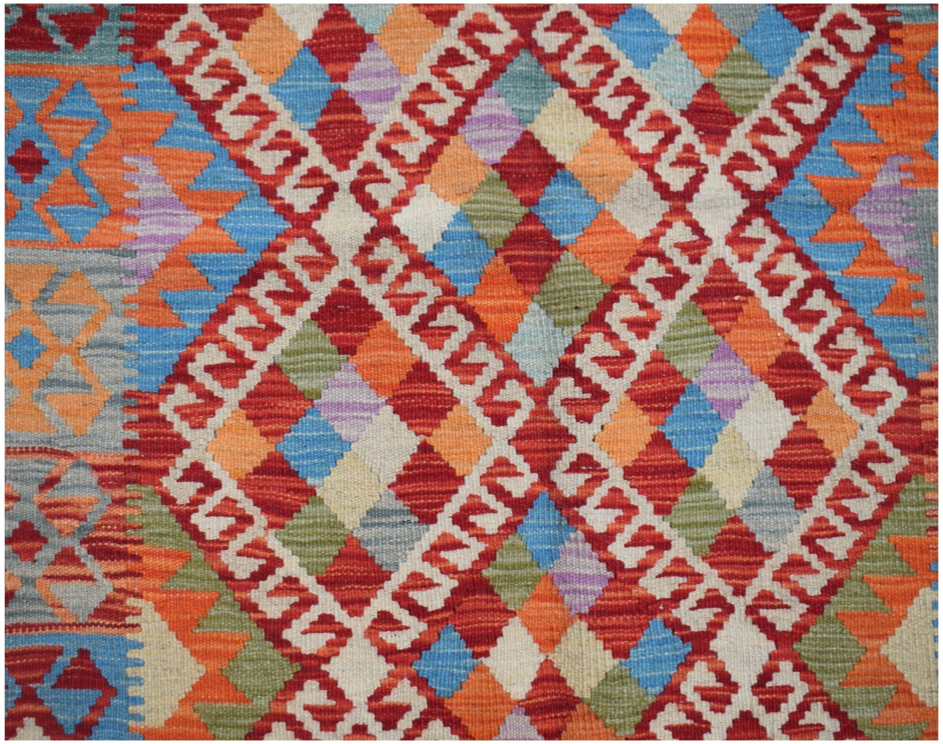Handwoven Afghan Maimana kilim featuring a vibrant geometric diamond pattern in wool.