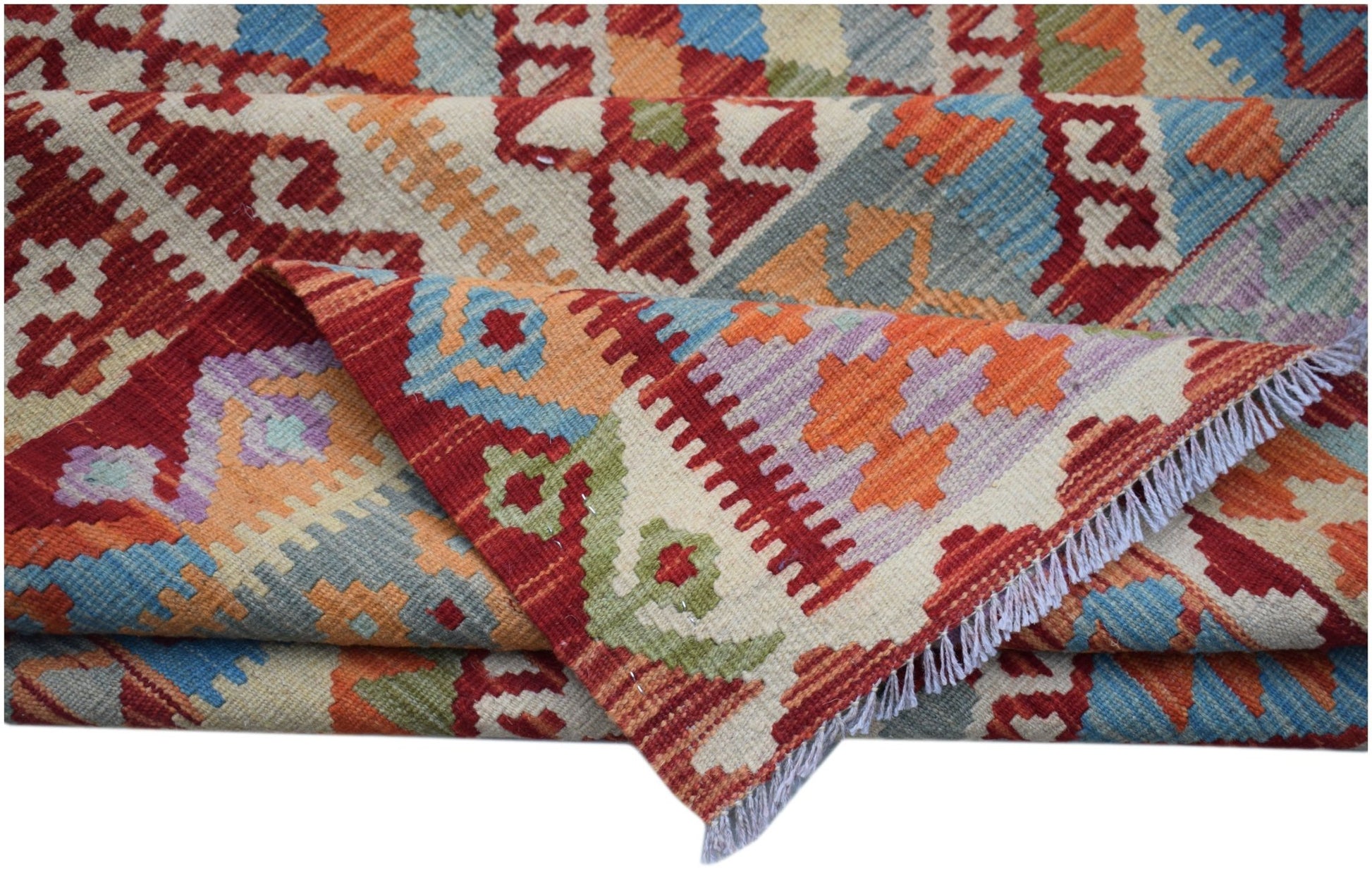 A handwoven Afghan Maimana kilim rug featuring a vibrant geometric pattern in wool.