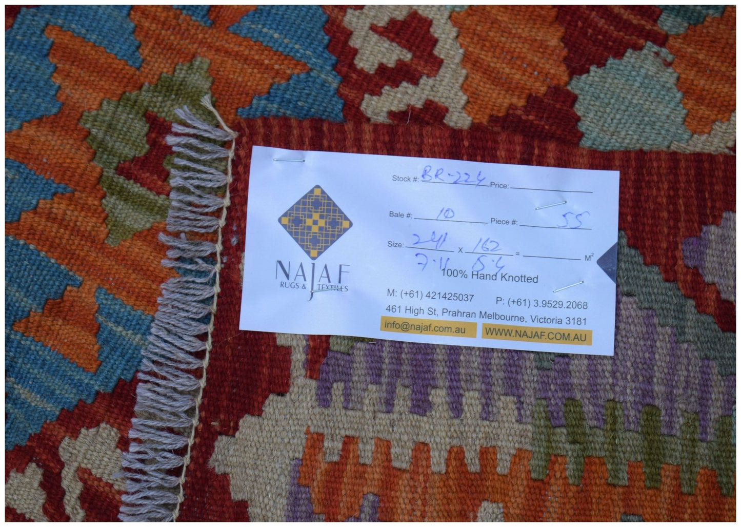 A flatwoven Afghan Maimana kilim featuring a vibrant geometric pattern in red, blue, and orange.