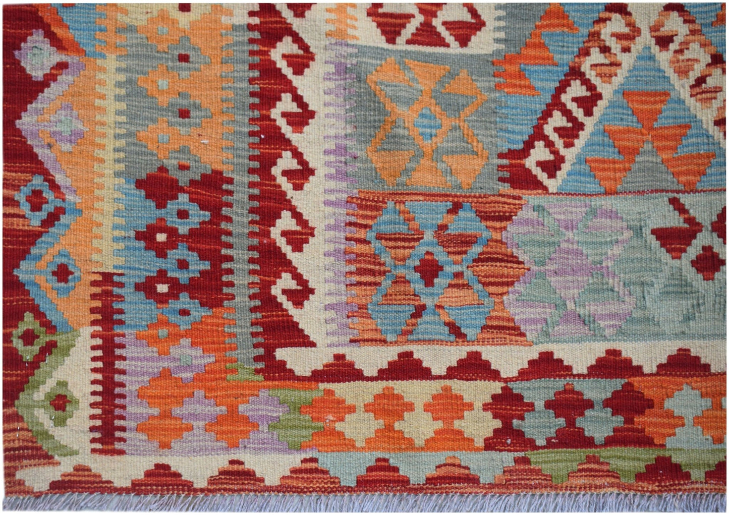 Handwoven Afghan Maimana kilim featuring a vibrant geometric pattern in wool.