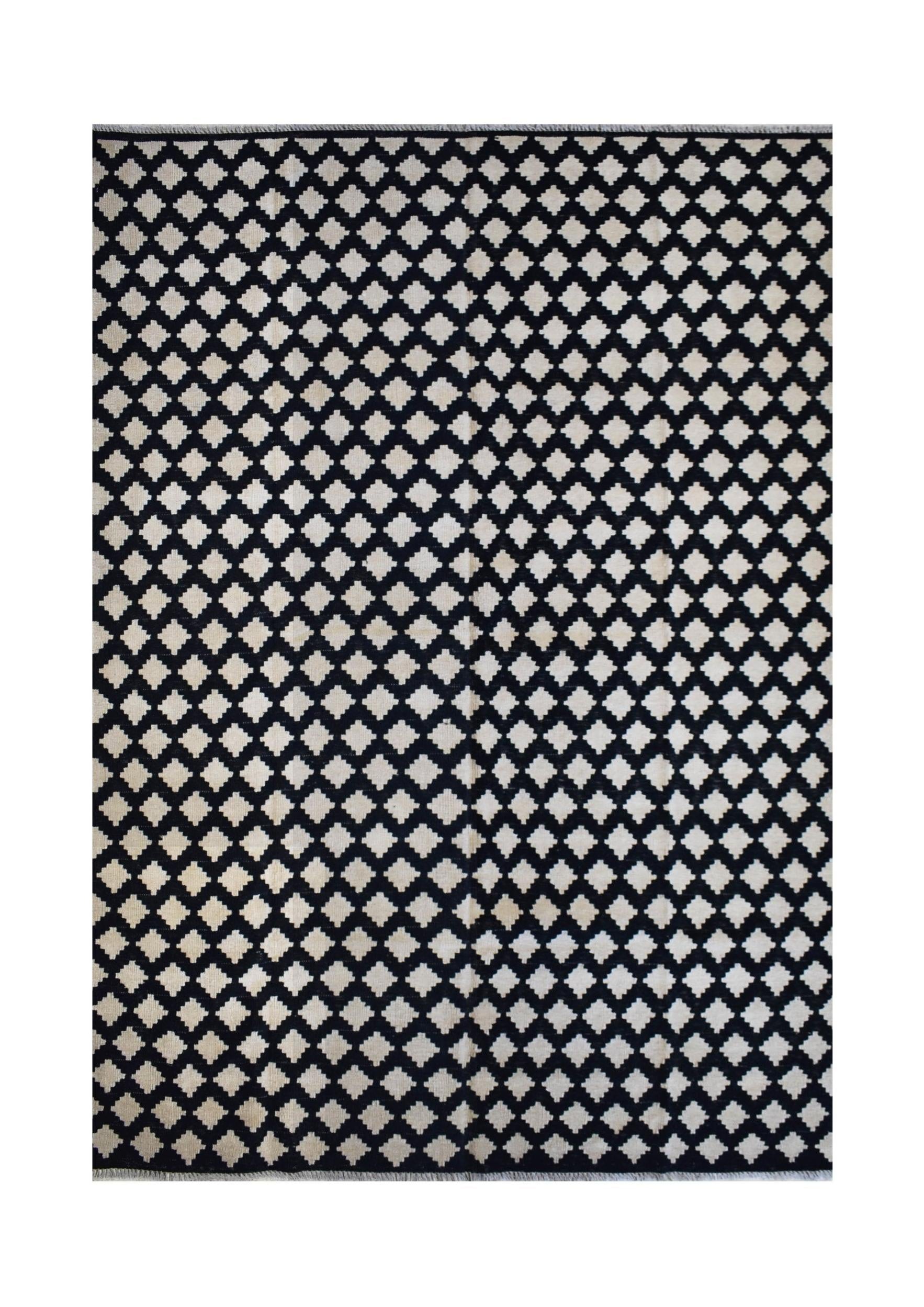 Handmade Afghan Maimana kilim rug featuring a repeating black and cream geometric diamond pattern.