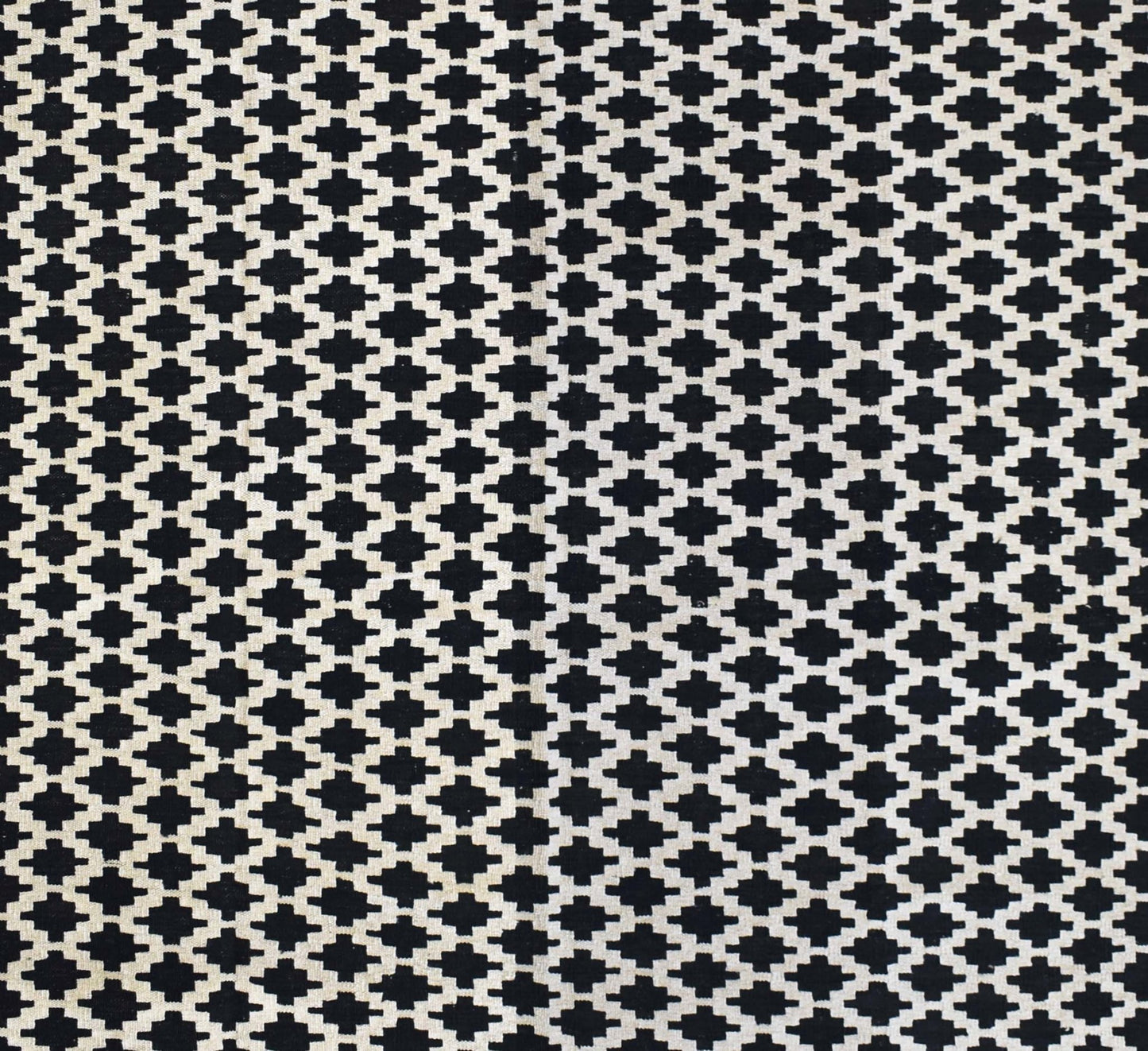 Handmade Afghan Maimana kilim rug featuring a repeating black and white geometric pattern.