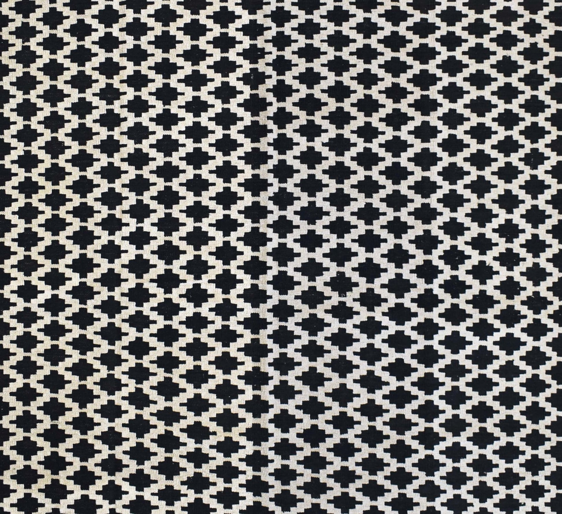 Handmade Afghan Maimana kilim rug featuring a repeating black and white geometric pattern.