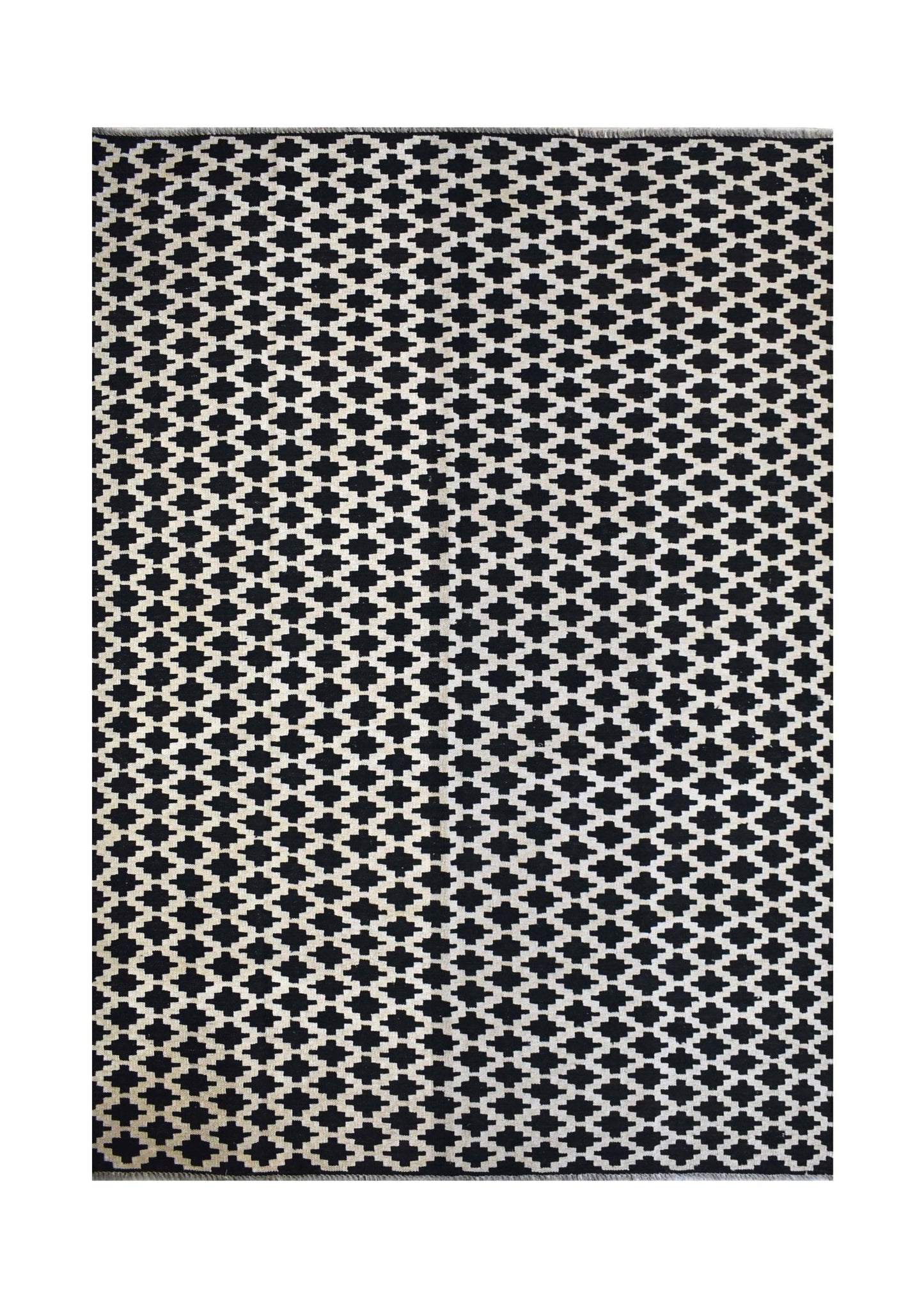 Handmade Afghan Maimana kilim rug featuring a black and white geometric pattern.