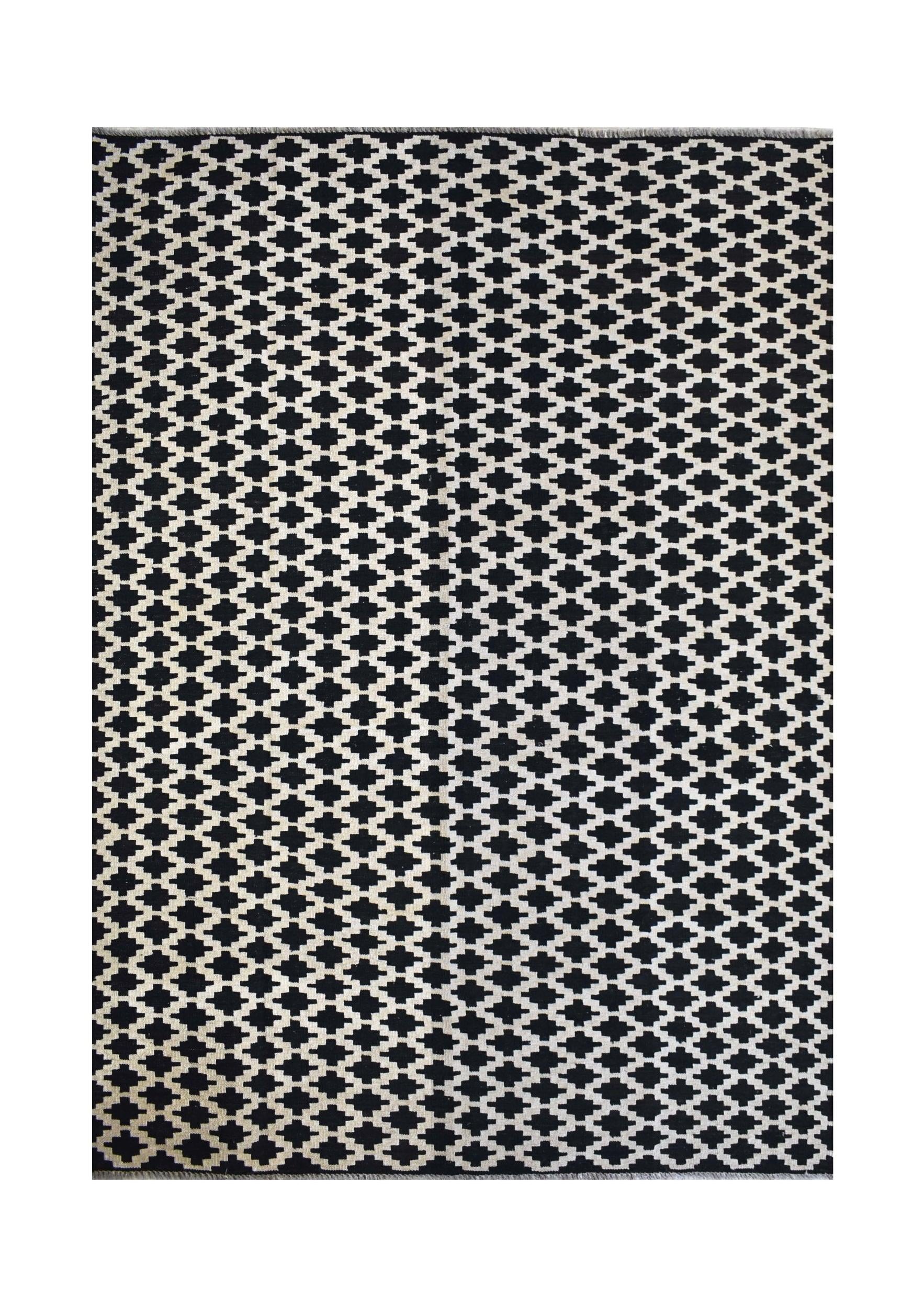 Handmade Afghan Maimana kilim rug featuring a black and white geometric pattern.