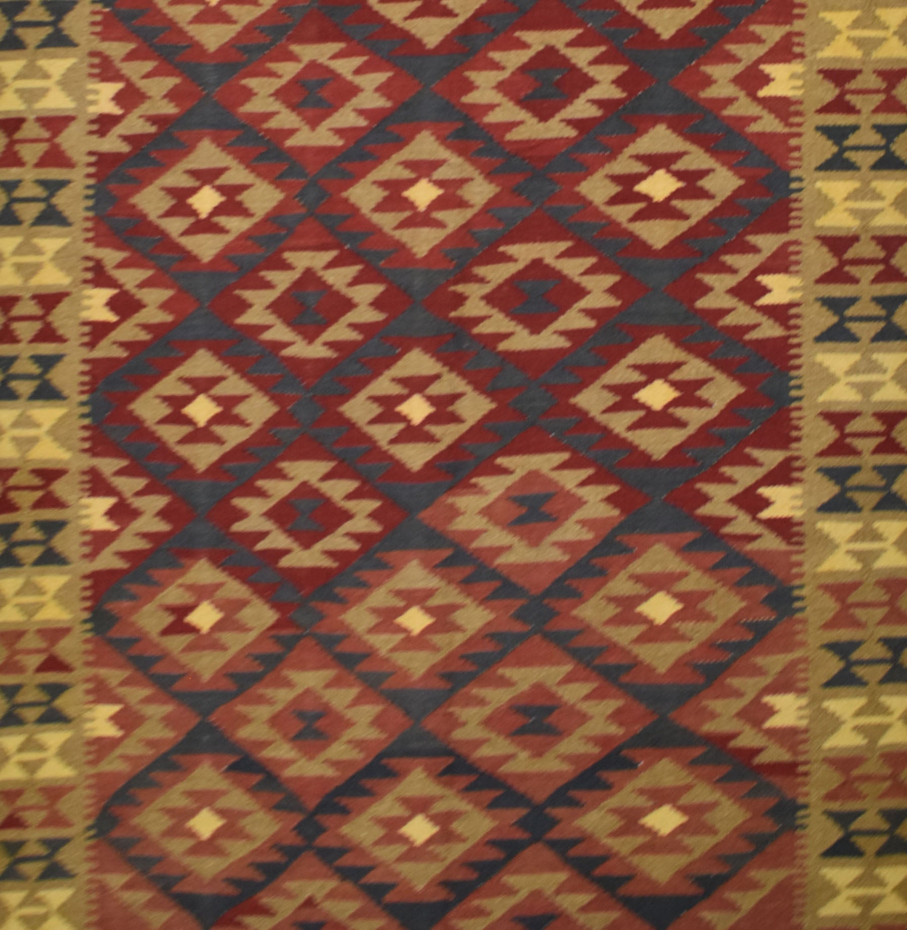 Handmade Afghan Maimana kilim rug featuring a repeating geometric diamond pattern in earthy tones.