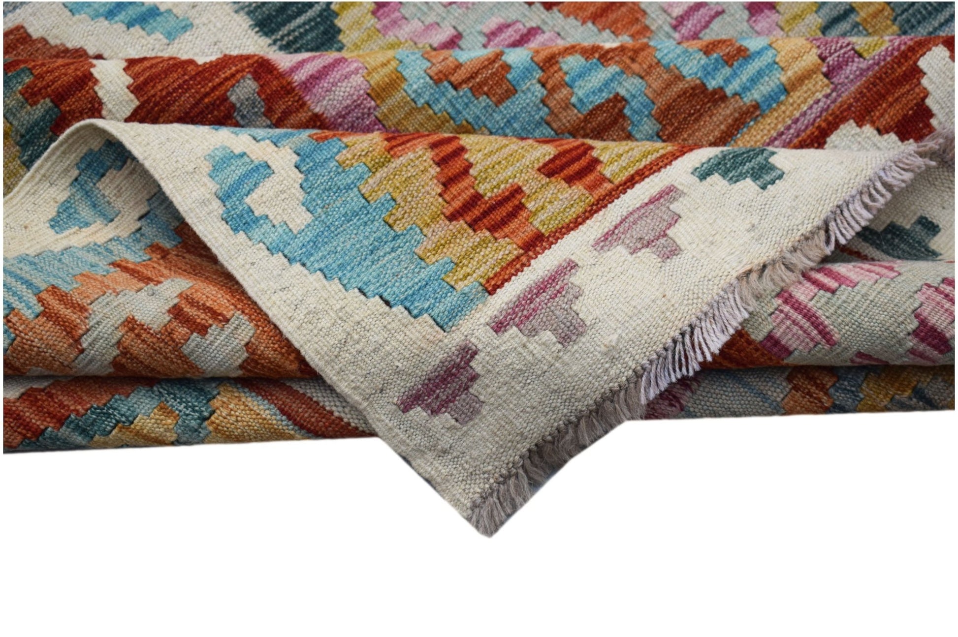 A handwoven Afghan Maimana kilim rug featuring a colorful geometric pattern and fringed edges.