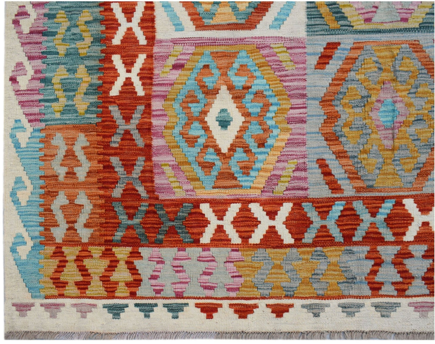 Handwoven Afghan Maimana kilim rug featuring a vibrant geometric pattern in wool.