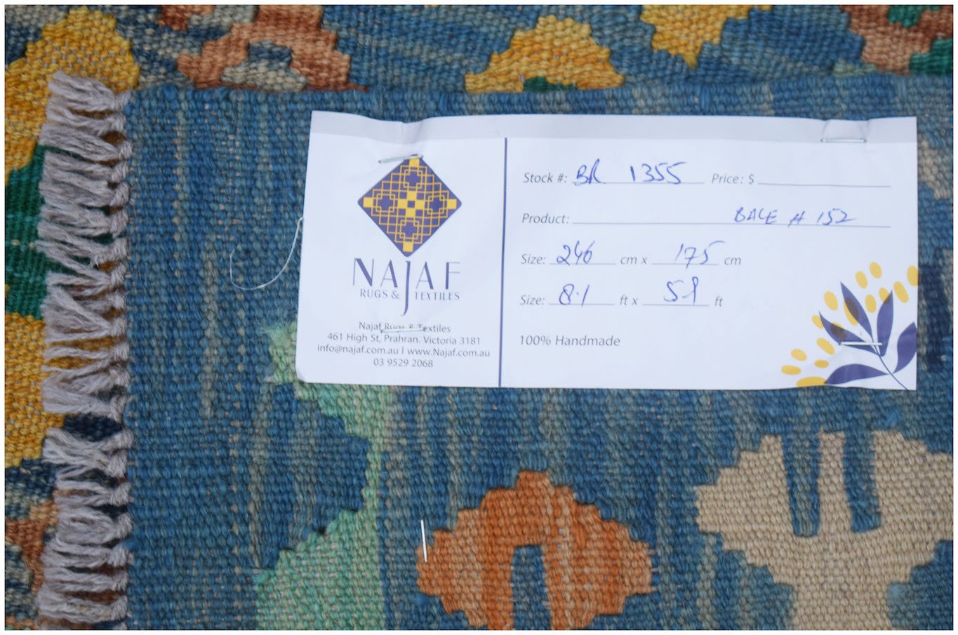 A handmade Afghan Maimana Kilim featuring a blue background with geometric orange and yellow motifs.