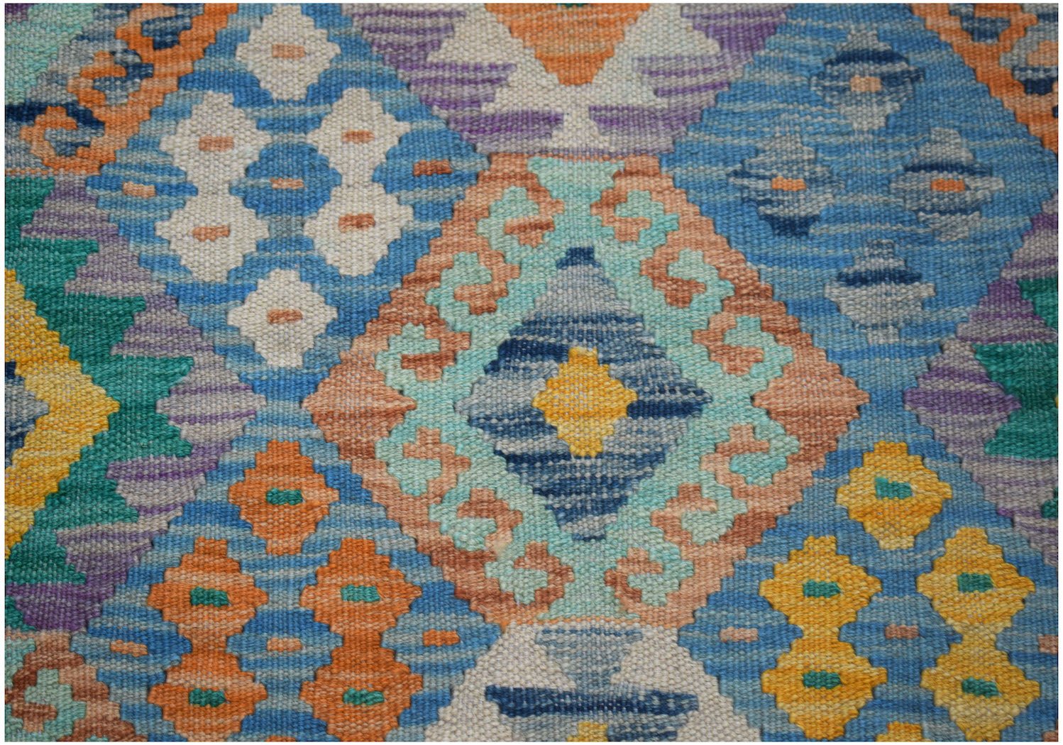 Handwoven Afghan Maimana kilim rug featuring a vibrant geometric diamond pattern in wool.