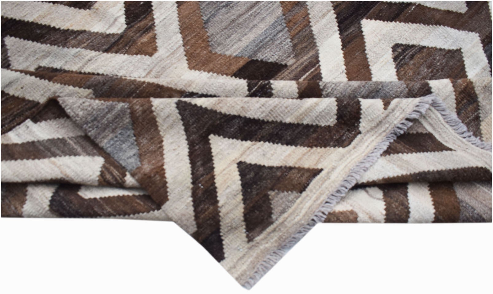 A handmade Afghan Maimana kilim rug featuring a geometric pattern in shades of brown and cream.