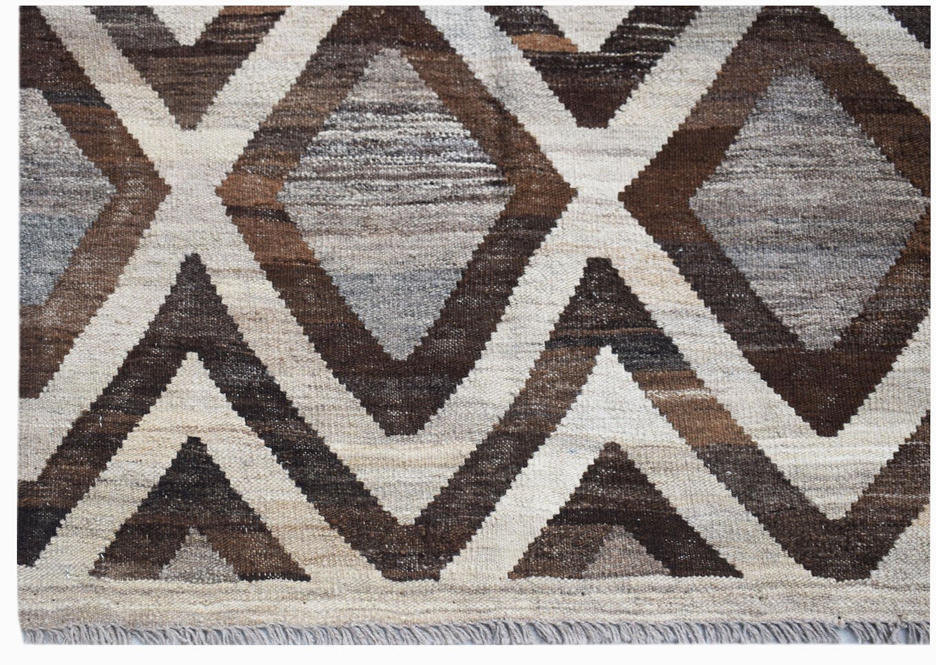 Handwoven Afghan Maimana kilim rug featuring a geometric diamond pattern in brown and cream tones.