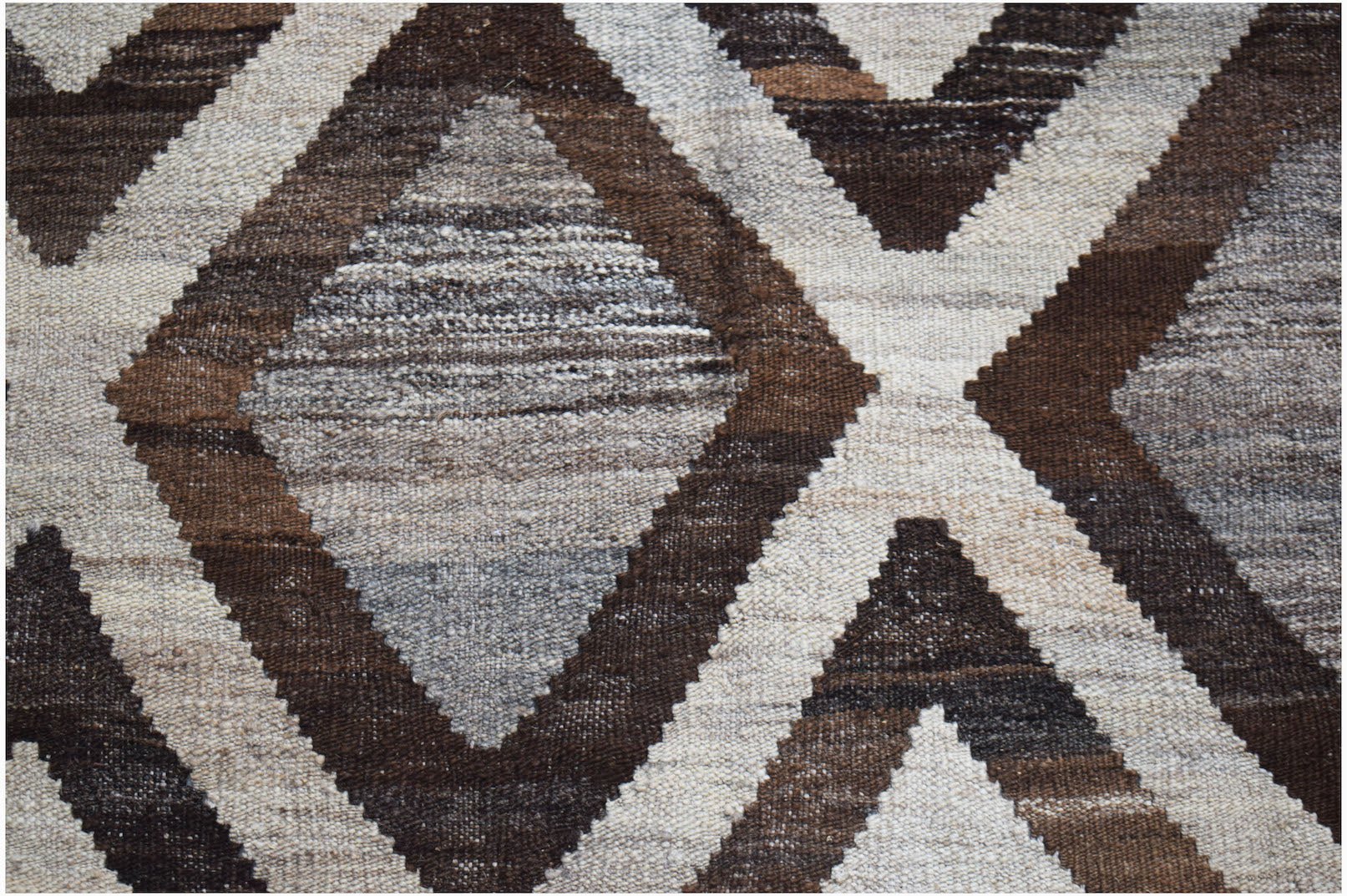 Handwoven Afghan Maimana kilim featuring a geometric diamond pattern in shades of brown and cream.