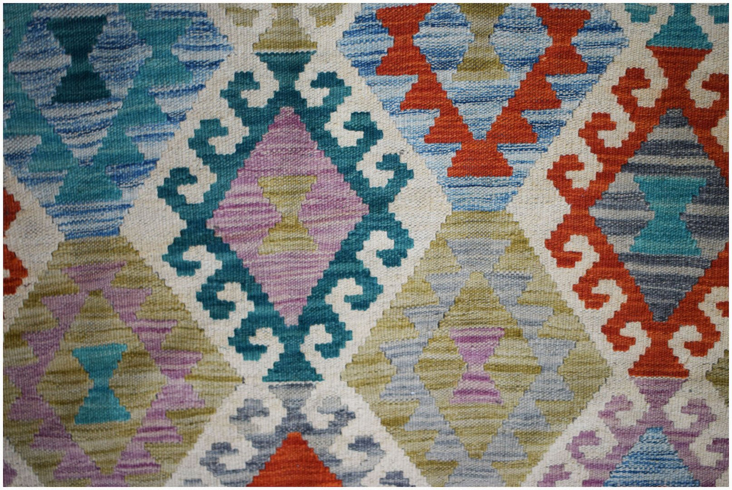 Handwoven Afghan Maimana kilim featuring a vibrant geometric diamond pattern in wool.