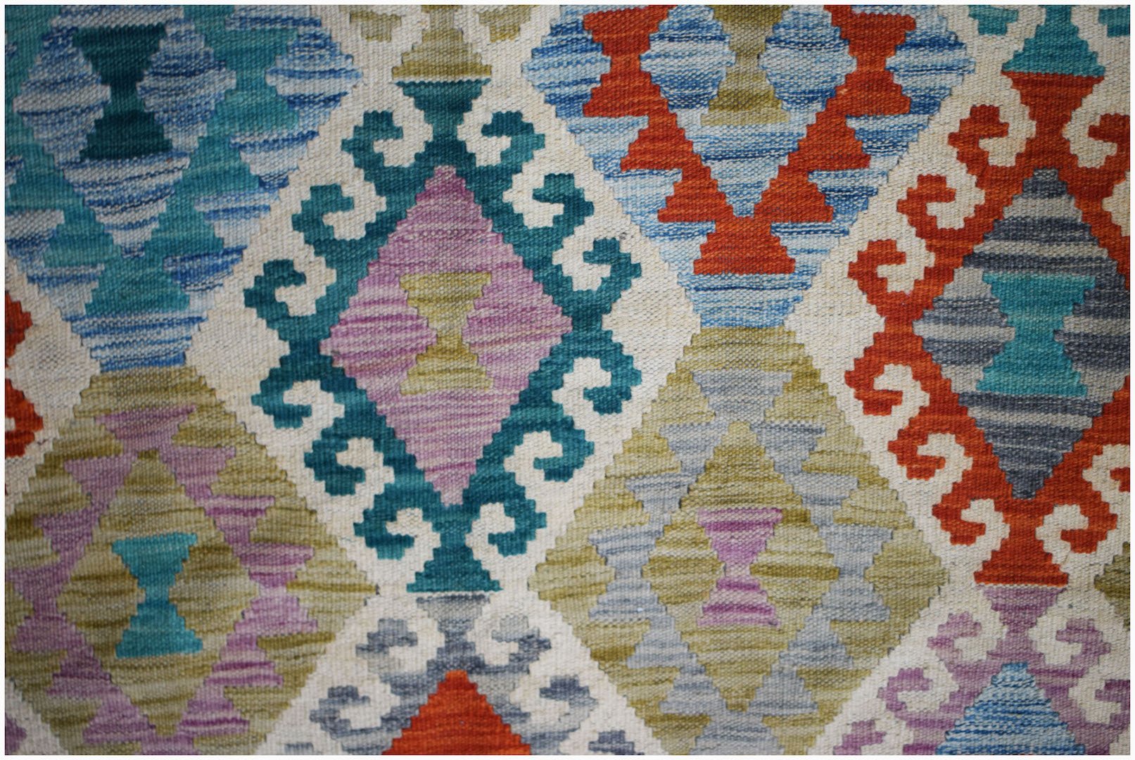 Handwoven Afghan Maimana kilim featuring a vibrant geometric diamond pattern in wool.