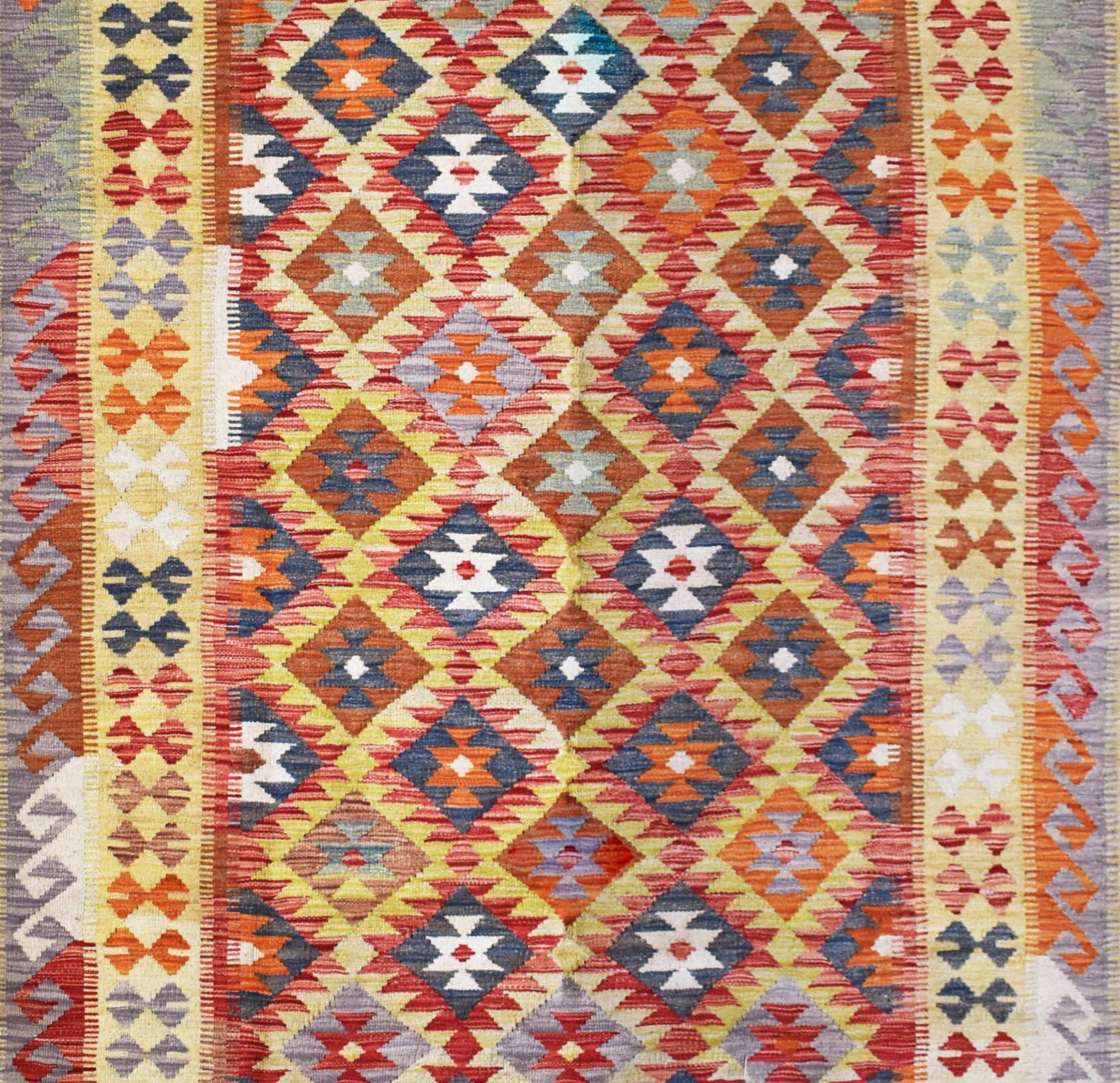 Handmade Afghan Maimana kilim rug featuring a vibrant geometric diamond pattern in wool.