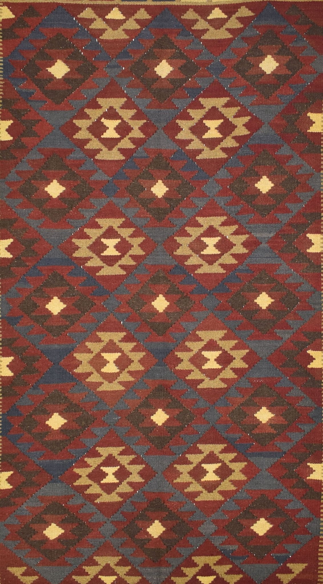 Handmade Afghan Maimana kilim rug featuring a repeating geometric diamond pattern in earthy tones.