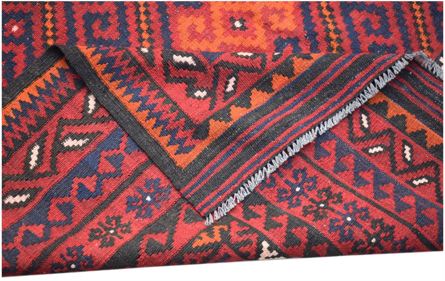 A handwoven Afghan Maimana kilim featuring geometric patterns in red, blue, and black wool.