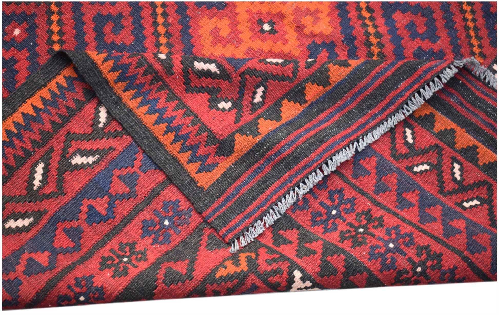 A handwoven Afghan Maimana kilim featuring geometric patterns in red, blue, and black wool.