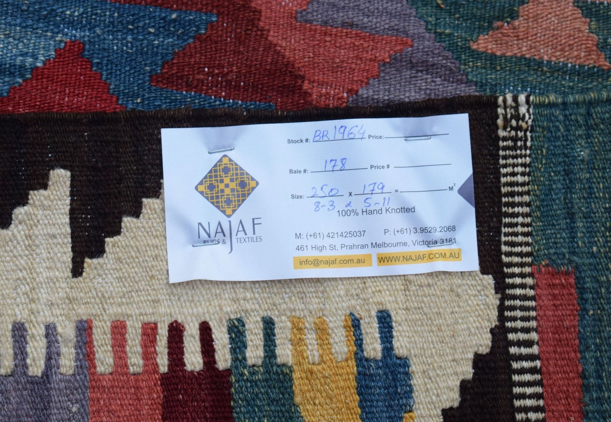 A handmade Afghan Maimana kilim featuring a geometric pattern in red, blue, and cream wool.