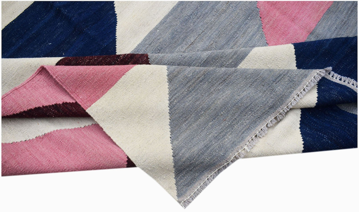 Handwoven Afghan Maimana kilim rug featuring a geometric pattern in blue, pink, grey, and cream.