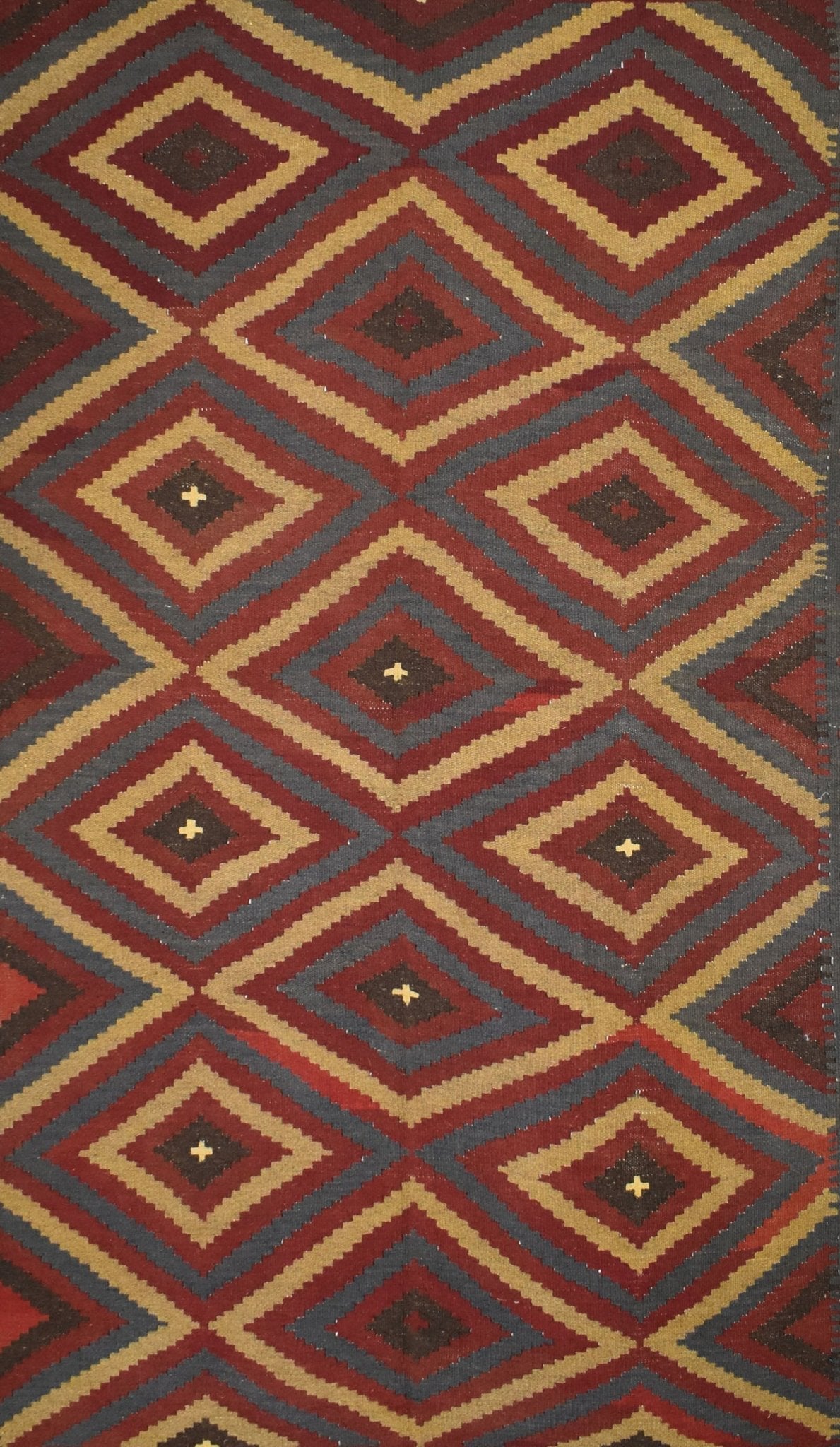 Handmade Afghan Maimana kilim rug featuring a repeating geometric diamond pattern in warm tones.